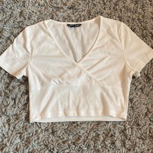 white crop top, tight fitting, crossover neckline